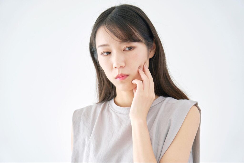 頬を気にする女性